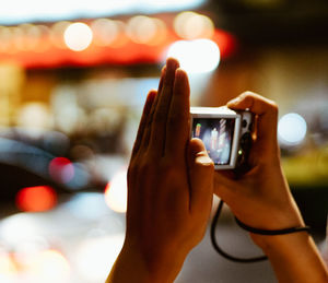 Close-up of hand photographing with camera