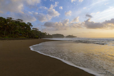 Scenic view of beach against sky during sunset