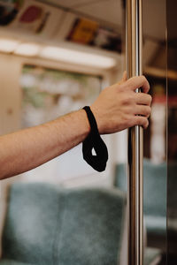 Close-up of man hand holding glass window