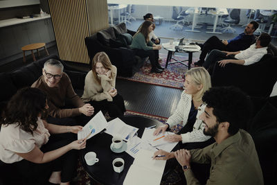 Group of business people having meeting in lobby