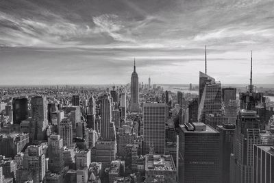 City skyline against cloudy sky