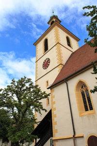 Low angle view of bell tower against sky