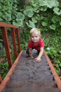 Full length of boy sitting on bench