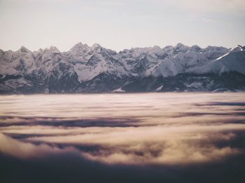 Scenic view of snowcapped mountains against sky during sunset