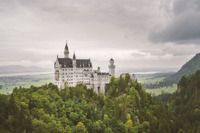 Panoramic view of trees and buildings against sky