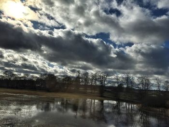 Scenic view of lake against cloudy sky