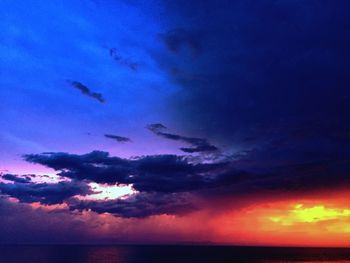 Low angle view of dramatic sky over sea during sunset