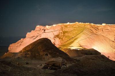 Scenic view of rock formation against sky at night