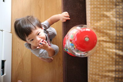 Boy playing with jar with candies