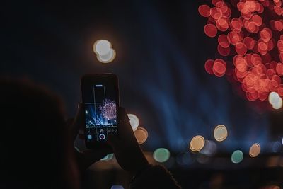 Low angle view of illuminated smart phone at night