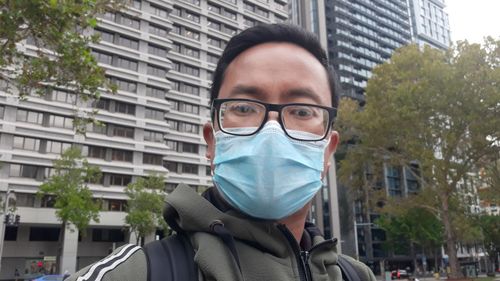 Portrait of young man standing in city