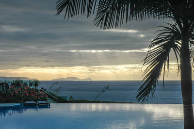 Scenic view of swimming pool against sky during sunset