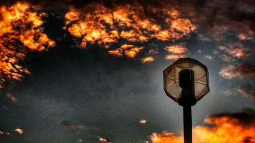 Low angle view of street light against sky at sunset