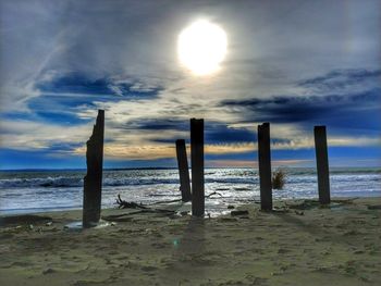 Scenic view of beach against sky during sunset