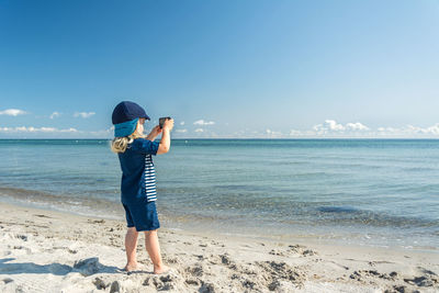 Full length of man on beach against sky