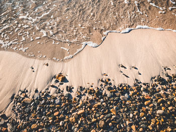 High angle view of pebbles on shore