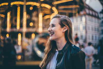 Young woman standing at amusement park