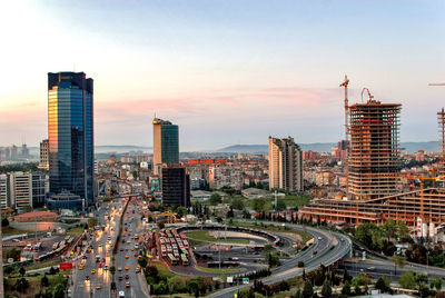 High angle view of city buildings against sky during sunset