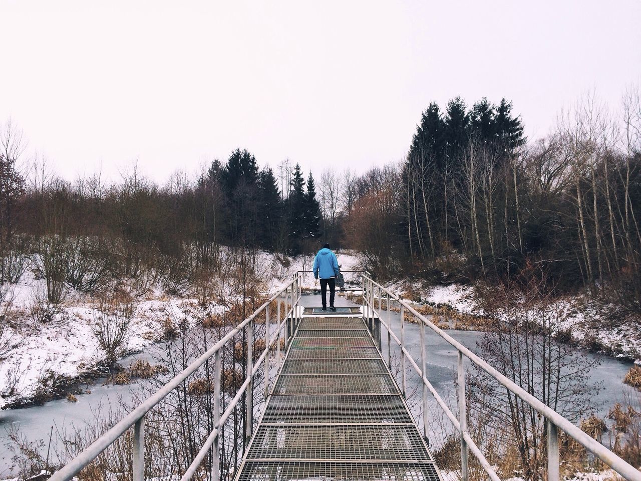 the way forward, full length, rear view, winter, season, lifestyles, clear sky, railing, snow, cold temperature, leisure activity, walking, diminishing perspective, standing, tree, nature, tranquility, weather