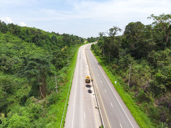 High angle view of highway amidst trees in forest