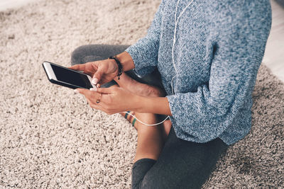 Midsection of woman using mobile phone