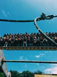 Panoramic view of people on water against blue sky