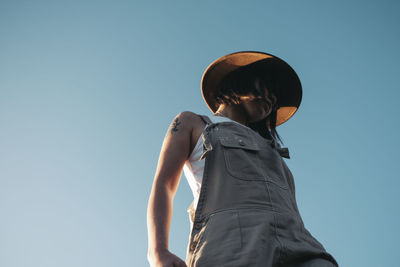 Low angle view of man standing against clear sky