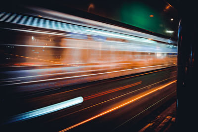 Blurred motion of light trails on road at night