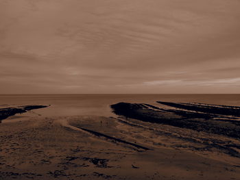 Scenic view of beach against sky during sunset