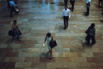 High angle view of people walking on floor in city