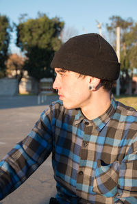 Midsection of  handsome man wearing hat looking away