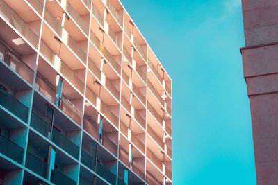 Low angle view of modern building against clear blue sky