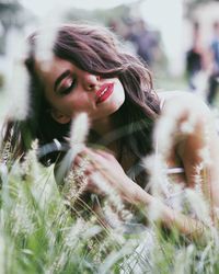 Close-up of young woman on field