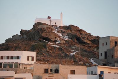 Buildings in city against clear sky