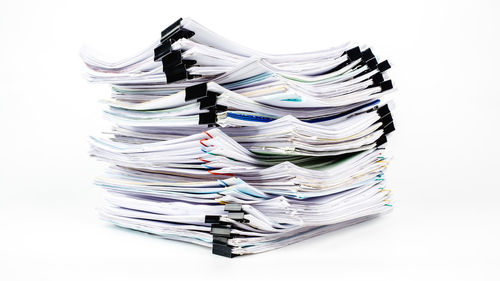 Close-up of paper stack against white background