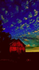 Red building against sky at night