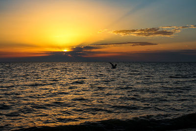 Scenic view of sea against orange sky
