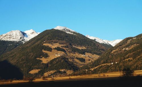 Scenic view of mountains against clear blue sky