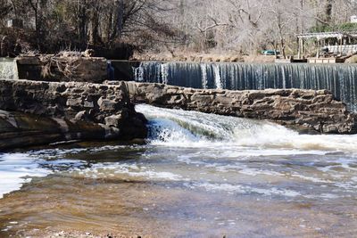 Scenic view of waterfall against sky