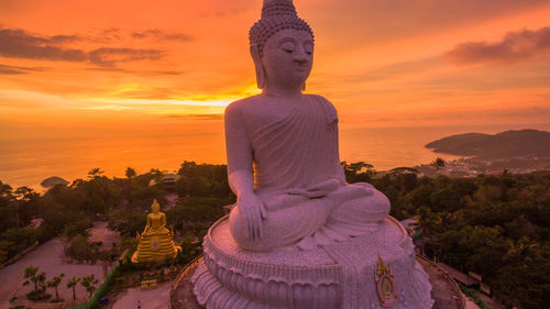 Statue of temple against sky during sunset