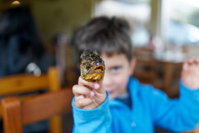 Close-up portrait of boy holding ice cream