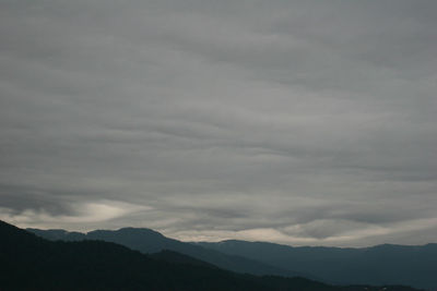 Scenic view of silhouette mountains against sky