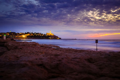 Scenic view of beach against sky at night