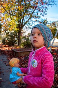 Cute girl looking up while standing outdoors