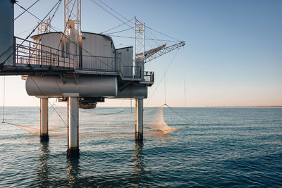 Lifeguard hut on sea against clear sky