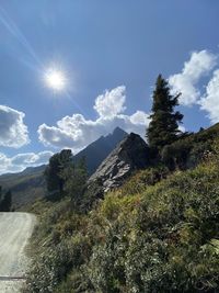 Scenic view of mountains against sky on sunny day