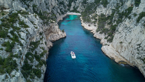 High angle view of rock amidst sea