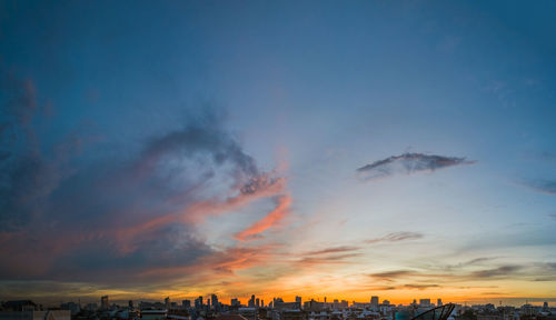 View of cityscape against cloudy sky