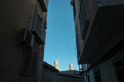 Low angle view of buildings against clear blue sky