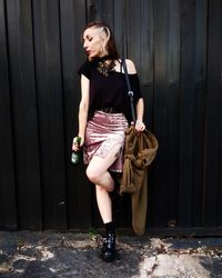 Portrait of young woman standing outdoors